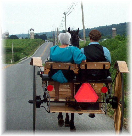 Amish couple riding to youth meeting
