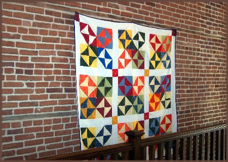 Quilt on brick wall