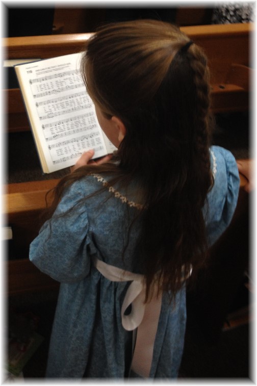 Child singing from hymnal 09-28-14