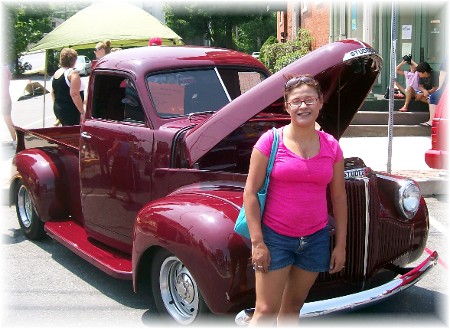 Ester is standing by a beautifully restored Studebaker pickup