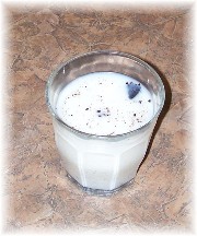 Glass of milk with crumbs