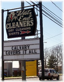 Witness sign: "Calvary Covers It All"