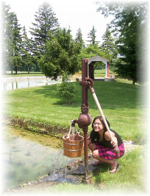 Ester by water pump at Longenecker farm in Lancaster County PA