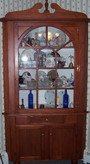 Cherry corner cabinet made by Raymond McGallicher