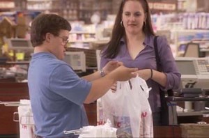Down Syndrome boy bagging groceries