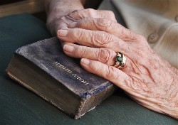 Old hands on old Bible