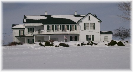 Brick farmhouse in snow