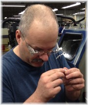 Randy inspecting machined part