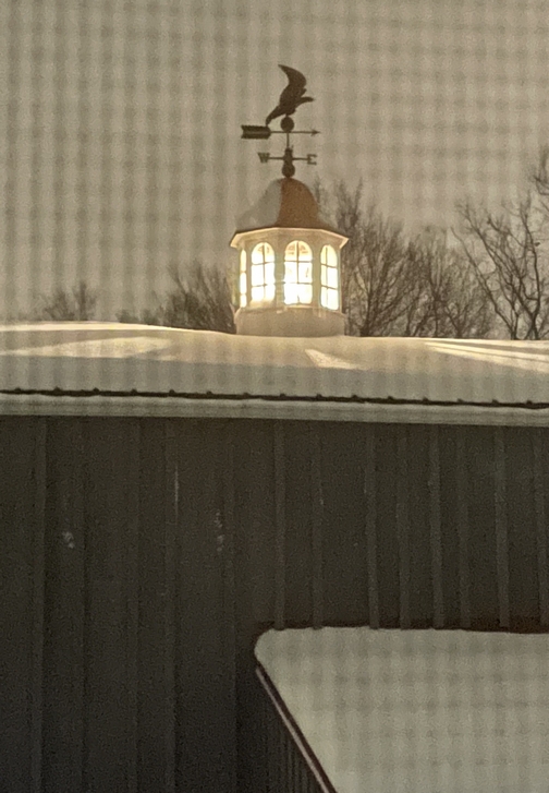 Barn cupola in snow at night